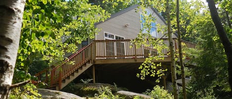 Back deck overlooks wooded mountainside and the 12.5 acre, secluded lake below. 