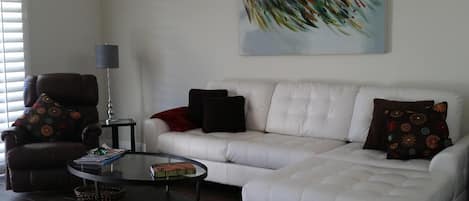 Newly remodeled living room with plantation shutters ,