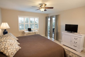 King Size bed with water views, plantation shutters and access to lanai.