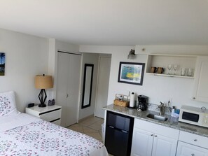 studio with queen bed and kitchenette