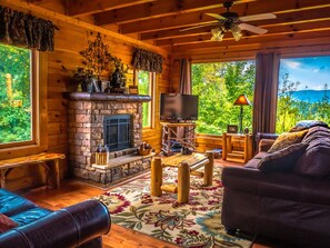 Spacious living room with comfy leather couches and large picture windows