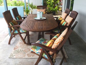 The covered lanai with seating for six.  To the left is an open court-type patio