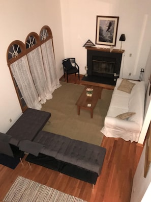 Living room with fireplace and cathedral ceiling 