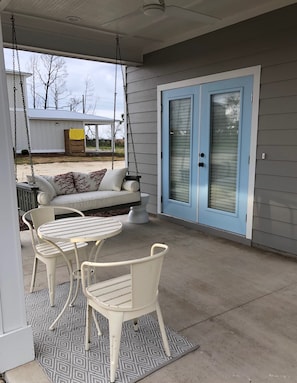 Front porch with swing & bistro table and chairs