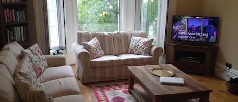 Sitting room with 2 settees, HDTV (shown from position of dining table)