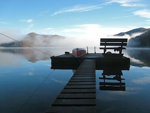 Misty morning view of lake and dock from stone steps