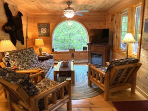 Living room looks out to wooded back yard.  