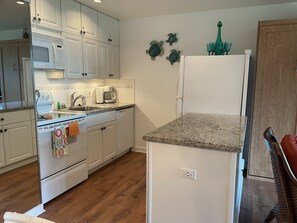 Fully appointed kitchen with appliances, dishes, utensils, and linens 