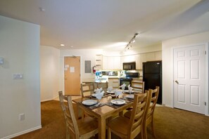 Dining area with kitchen in background