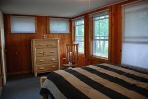 Downstairs bedroom with views of the lake, just outside the windows.  Double bed