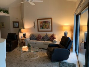 Living room with slider to patio and view of women's 9th tee