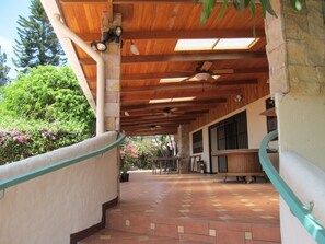 Front porch, outdoor kitchen to right and old ping pong table in background