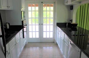 French doors leading from the Kitchen to the screened-in lanai.
