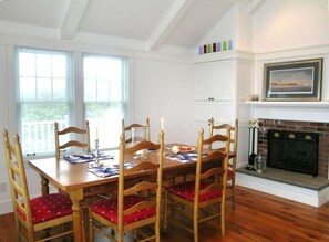 Living/dining area with fireplace and built-in cabinet