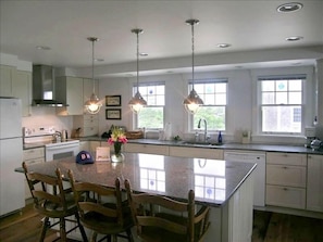 Kitchen with center island and quartz countertops