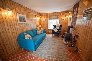 The snug woodlined sitting room to rear of property with woodburner,TV and DVD.