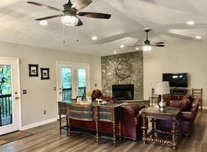 Great room has leather sofa, love seat, recliner w/ ottoman.