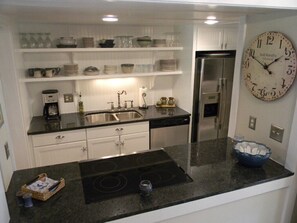 Newly remodeled kitchen with new granite counters and stainless steel appliances