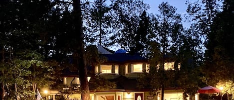 Night time view of the house from the lake in the summer.