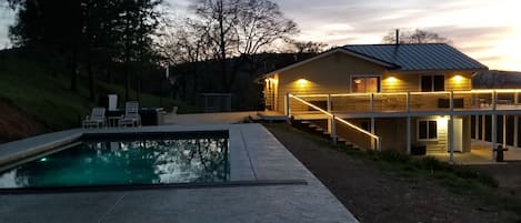 View of pool and spa  at night.