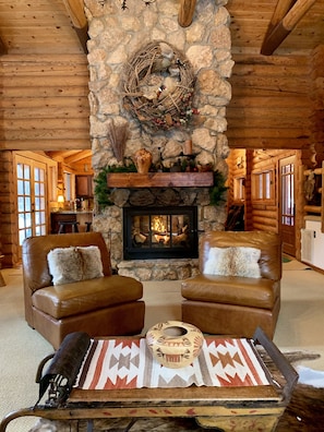 Great room with a two-story double sided fireplace