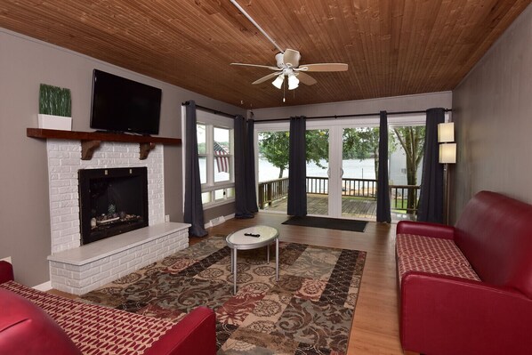 Living Room with 2 sliding glass doors. Private balcony steps away from lake.