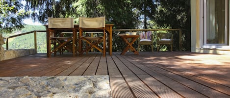 Wooden deck with a view to the mountains and sunset