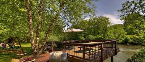 Large deck over the Toccoa river with seating to 
enjoy the view and fish.