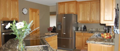 Kitchen with brand new appliances and solid granite slab