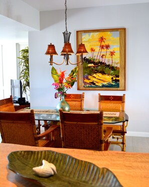 Comfortable dining sits six, enhanced by Darrel Hill painting and mango frame.