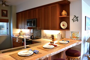 Beautiful custom kitchen with live edge mango wood.  