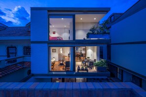 Twilight from social balcony toward the apartment: MBR/deck, living room/balcony