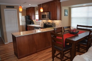 Natural granite, wood, and stone finishes are located throughout the condo.