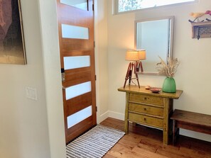 Large entryway with bench, entry closet and trays for boot storage