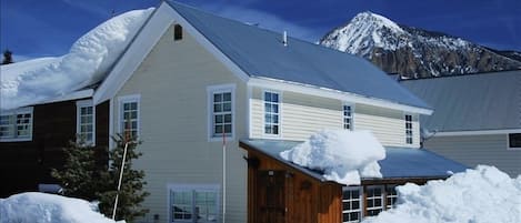 House with Mt Crested Butte to the back. Free bus for ski slopeside delivery.