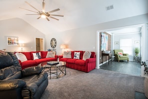 Living room with sunroom and workspace.