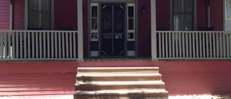 front porch, with rocking chairs, overlooking, woods, pond, trails, and wildlife