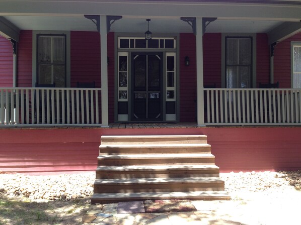 front porch, with rocking chairs, overlooking, woods, pond, trails, and wildlife