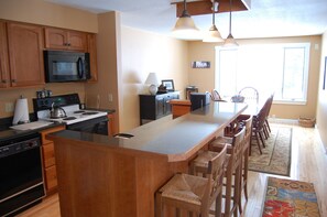 Kitchen with Island / Stools and Dining Area with Large Window