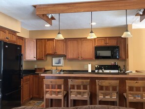 Kitchen with Countertop Bar and Stools