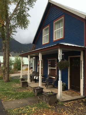 Front of house on a fall day, clouds hiding Turk and Sultan Mountains.