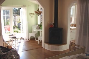 Great gas fire heating stove.  Peak of kitchen and garden nook with dining table 
