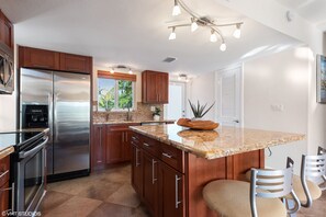 Kitchen includes access to front porch with table and chairs.