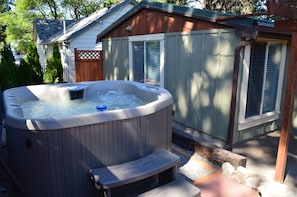 Private hot tub in the fully fenced backyard