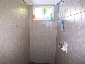 Open the rear exterior bungalow door and step into an extra large tiled shower