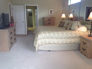 Master bedroom with King bed, dressers, walk-in closets and ensuite