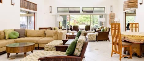 Living room with 16 foot ceiling, upper windows and plenty of seating.
