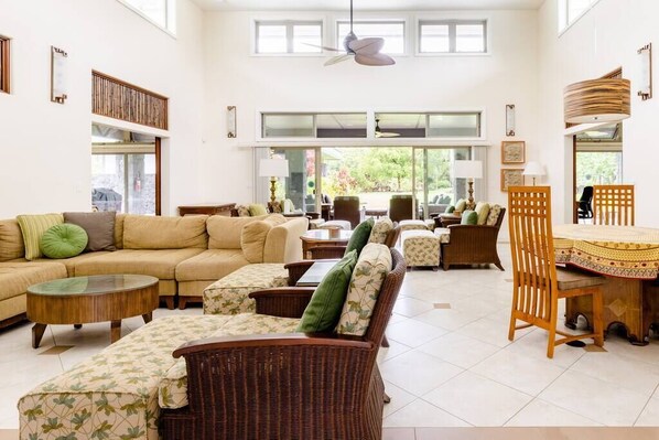 Living room with 16 foot ceiling, upper windows and plenty of seating.
