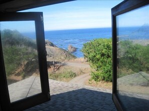 The upstairs bedroom windows open wide to take in the ocean scents and sounds.