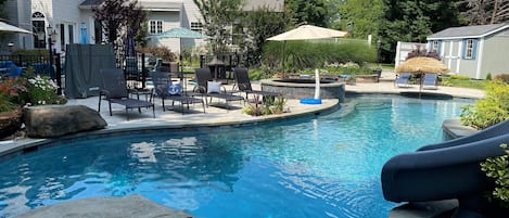 50+ foot heated pool with large tanning ledge, jumping rocks, waterfalls, slide